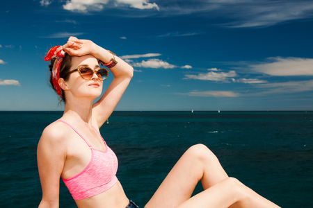 attractive girl model in sunglasses sunbathing on beachの写真素材