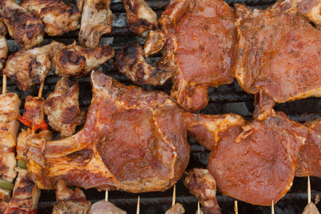 raw barbecue meat on grillの写真素材