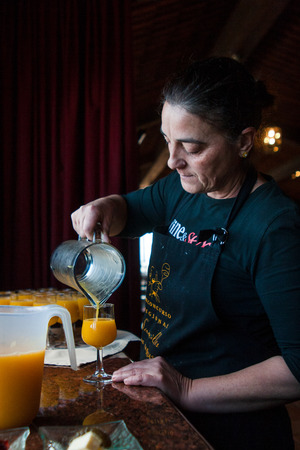 Tenerife, Spain, January 2015: Waitress pours fresh juice for customers on Bodega Monje- one of leading wine manufactures on north of Tenerifeのeditorial素材