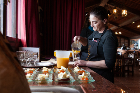 Tenerife, Spain, January 2015: Waitress pours fresh juice for customers on Bodega Monje- one of leading wine manufactures on north of Tenerifeのeditorial素材