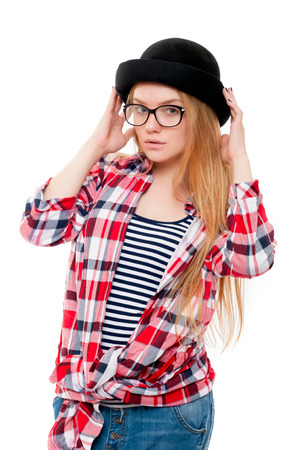 Young teenage girl in black hat, glasses and colorful clothes isolated on white backgroundの写真素材