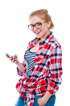 Teenage girl or young woman in glasses looking in camera and laughingの写真素材