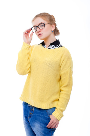 Teenage girl or young woman in yellow sweater and glassesの写真素材