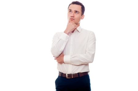 Young man in business suit thinking. Businessman making decision. Man looking up isolated on white.の写真素材