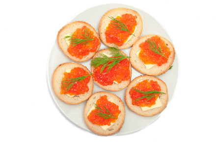 Bread with butter and red caviar in white plate. Sandwiches with red caviar.の写真素材