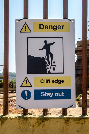 Danger Cliff Edge Stay Out warning sign on a quarry gateの写真素材