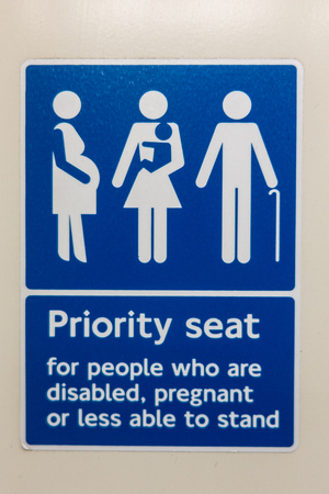Priority seat for people who are disabled, pregnant or less able to stand sign on a London trainの写真素材