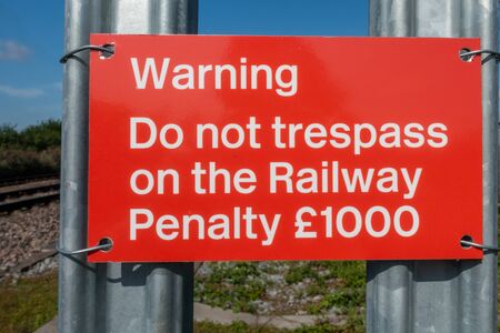 Do not trespass on the railway warning sign on a palisade fenceの写真素材