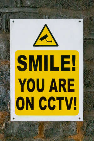 Smile you are on CCTV sign on a brick wallの写真素材