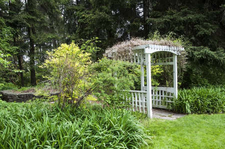 A white trellis in the garden in spring.