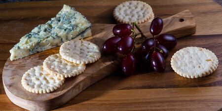 Crumbly Cheese Board with biscuits and grapes for Desertの写真素材