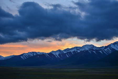 Sayram Lake features transparent water with changing colors, snow-covered mountains, numerous kinds of wildflowers as well as breathtaking sunrise and sunset, which together make for some of the most spectacular sights on earth.の写真素材