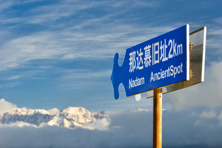 The road sign to Nadam beside Tarim Lake, standing alone in the morning sun and cold wind