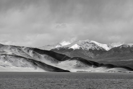 Baisha Lake in the Pamir Plateau of Xinjiang, with Baisha Mountain and emerald lake waterの写真素材