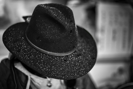 Snowflakes on the felt cowboy hat of Chinese Tibetansの写真素材