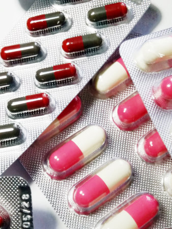 Colorful Capsules in Blister Packs Displayed on a Bright Surface
