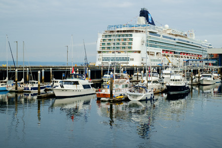 Seattle, WA, USA July 17 2016: Cruise ship with yachts in marina. Norwegian Cruise Lines Norwegian Pearl at Pier 66 at Bell Harbor Marinaのeditorial素材