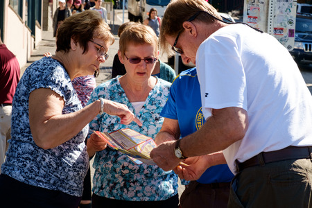 Seattle, USA July 24, 2016: Two mature female and two mature male tourists look at mapのeditorial素材