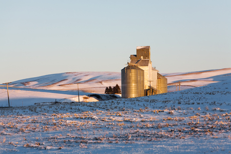 Grain silos on snow covered rolling hills of the Palouse region of Washington, USAの写真素材