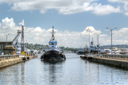 Seattle, USA June 12 2015: Kirby Corp. tugboat Paragon entering Hiram M Chittenden locks (Ballard Locks) to transit onto Puget Soundのeditorial素材