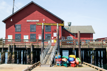 Coupeville, WA USA May 21, 2017: Rental kayaks of various colors at historic Coupeville Wharf which also houses the marina officesのeditorial素材