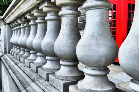 Marble column close up with red phone box in backgroundの写真素材