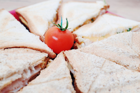 Breakfast: sandwiches with cheese and ham, decorated with cherry tomatoesの写真素材