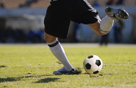 soccer player goalkeeper kick the ball during football matchの写真素材