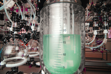 manufacture of medicines at a drug factory. green liquid in a flaskの写真素材