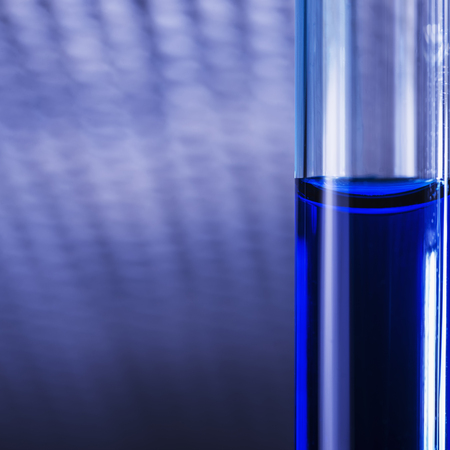 Blue liquid in tubes on blured medical backgroundの写真素材