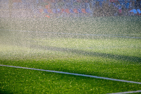 Irrigation turf. Sprinkler watering football field.の写真素材
