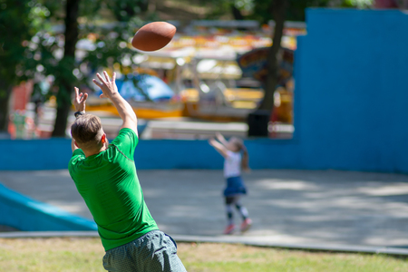 American Football Player Catching a touchdown Pass in park.の写真素材
