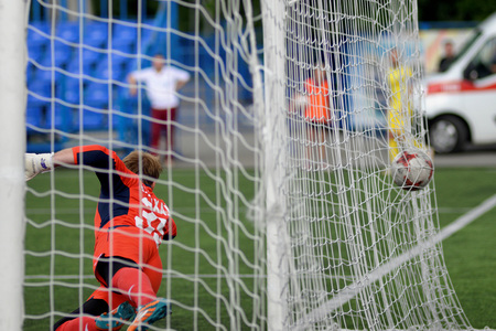 MINSK, BELARUS - JUNE 29, 2018: Goal - a soccer ball flies into the gates net during the Belarusian Premier League football match between FC Luch and FC BATE at the Olimpiyskiy stadium.のeditorial素材