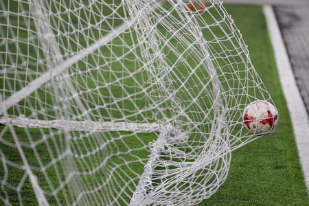 MINSK, BELARUS - JUNE 29, 2018: Goal - a soccer ball flies into the gates net during the Belarusian Premier League football match between FC Luch and FC BATE at the Olimpiyskiy stadium.のeditorial素材