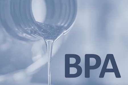 Plastic bottle and liquid stream. Bisphenol, text BPA FREE plastic photo.の写真素材