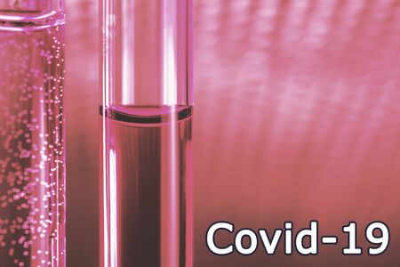 Covid-19. Red liquid vaccine in glass tubes.の写真素材