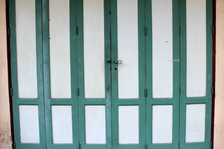 Green ancient wooden door as a backgroundの写真素材