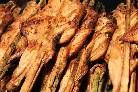 Grilled Chicken with Bamboo Clamp at a market of Bangkok, Thailandの写真素材