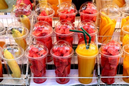 Bananas,red melons and ripe mangoes that are prepared for making smoothies at a market in Bangkok, Thailandの写真素材