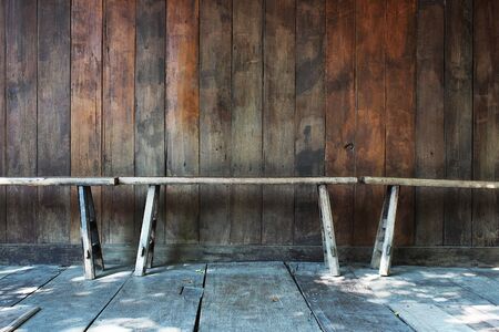 Wooden chairs placed on the balcony of an ancient house in Bangkok, Thailandの写真素材