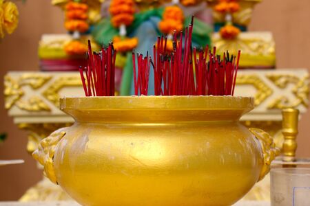 Golden incense burner filled with incense sticks, Bangkok, Thailandの写真素材