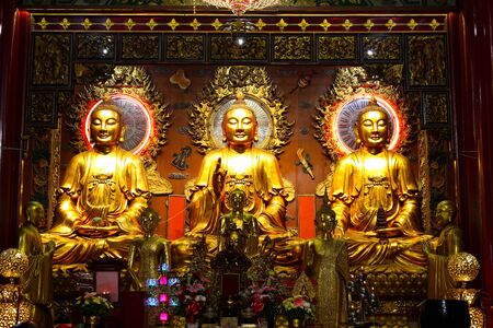 Three beautiful golden Buddha statue in Chinese temple, Bangkok, Thailandの写真素材