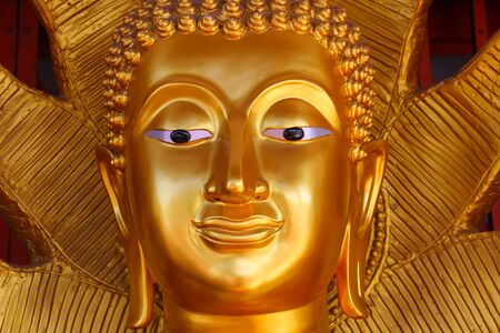 Face image of Golden Buddha statue in a Thai temple at Bangkok, Thailandの写真素材
