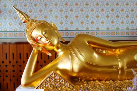 A beautiful Reclining Golden Buddha Statue in Thai temple at Bangkok, Thailandの写真素材