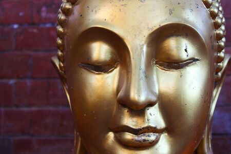 Face image of Golden Buddha statue at Thai temple, Bangkok, Thailandの写真素材