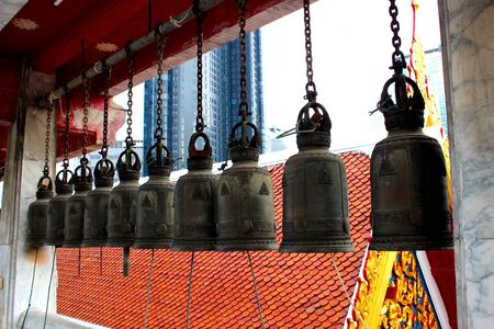 Black metal bells hung in row in thai temple, Bangkok, Thailandの写真素材
