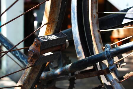 Rusty pedal and wheels of the ancient bicycle, Bangkok, Thailand