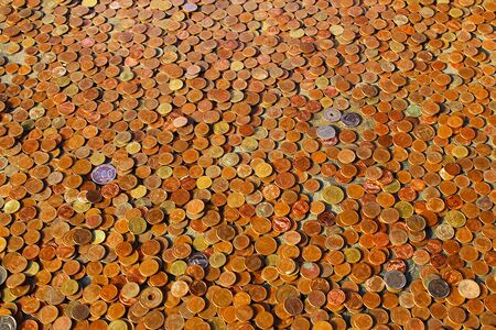 Coins that tourists use to drop donations to make merit in Thai temple, Bangkok, Thailandの写真素材