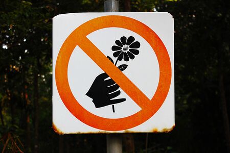 'Do not pick flowers' sign in a park at Bangkok, Thailand