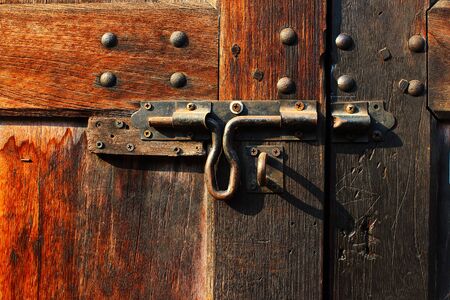 The hasp of the old wooden doors of Chinese house in the Chinatown at Bangkok, Thailandの写真素材
